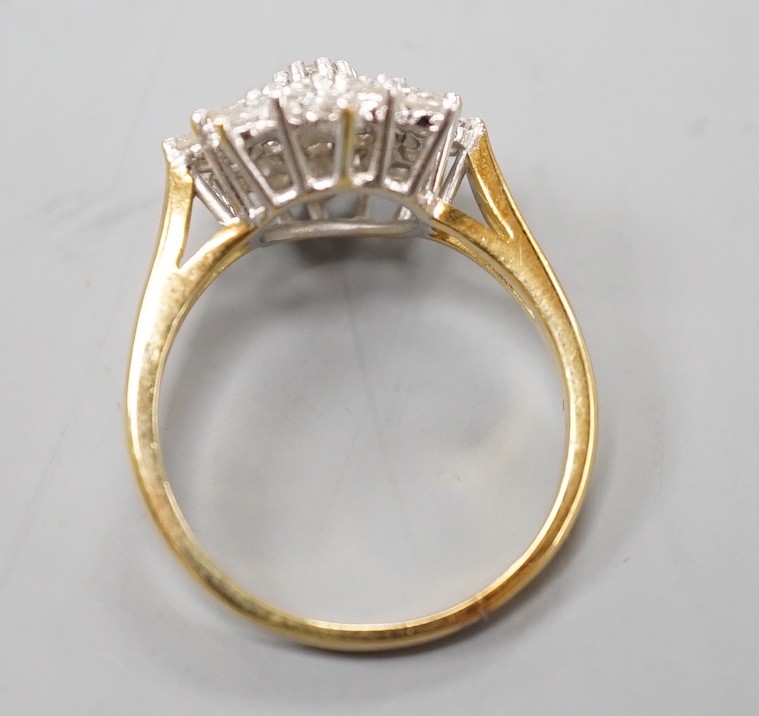 A modern 18ct gold and diamond cluster set flower head ring, size R/S, gross weight 5.5. grams.